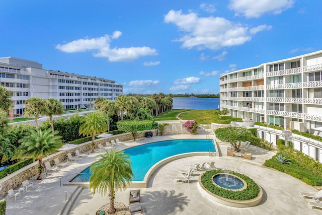 view of pool with a patio area and a water view