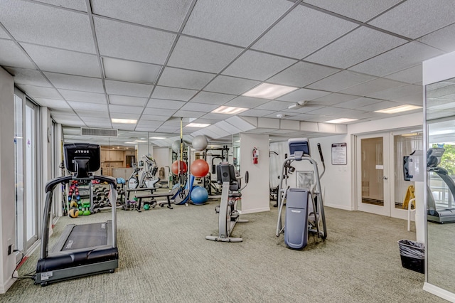 exercise room with carpet and a drop ceiling