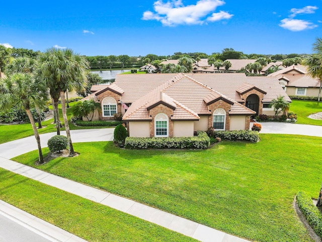 mediterranean / spanish-style house featuring a water view and a front yard