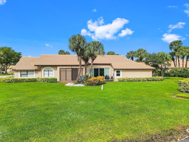 rear view of house with a yard