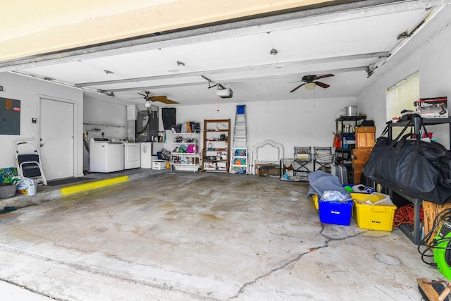 garage featuring electric panel, a garage door opener, washer and clothes dryer, and ceiling fan