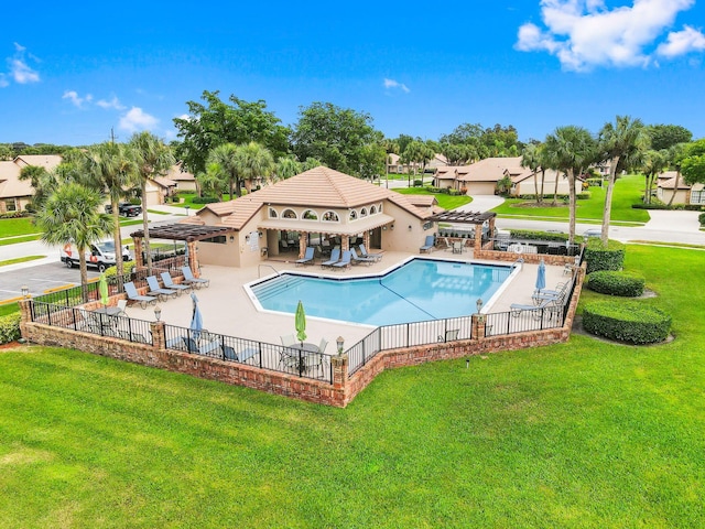 view of swimming pool with a yard and a patio