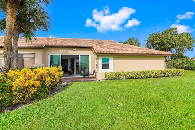 rear view of house with a patio area and a lawn