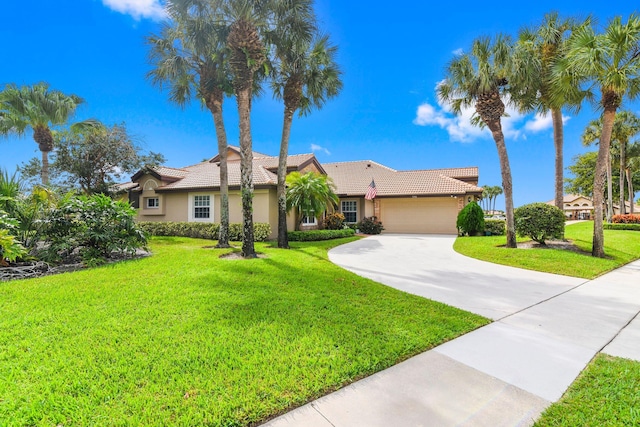 view of front of home with a front yard and a garage