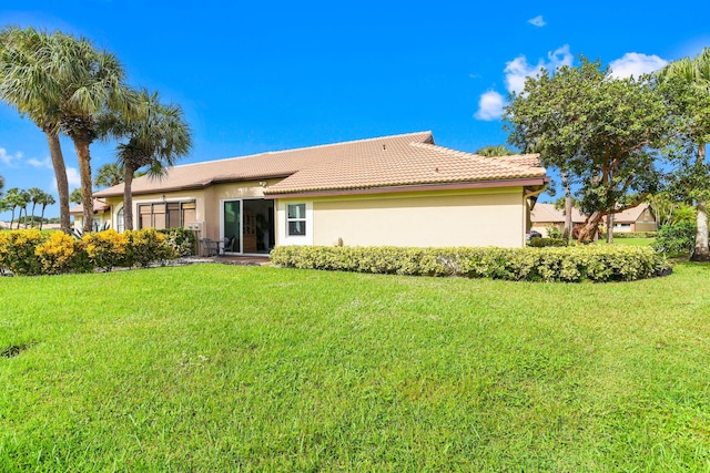 rear view of property with a yard