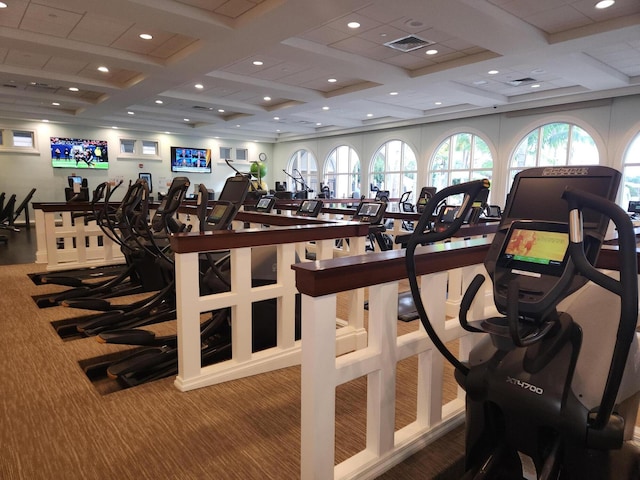 exercise room with carpet and coffered ceiling