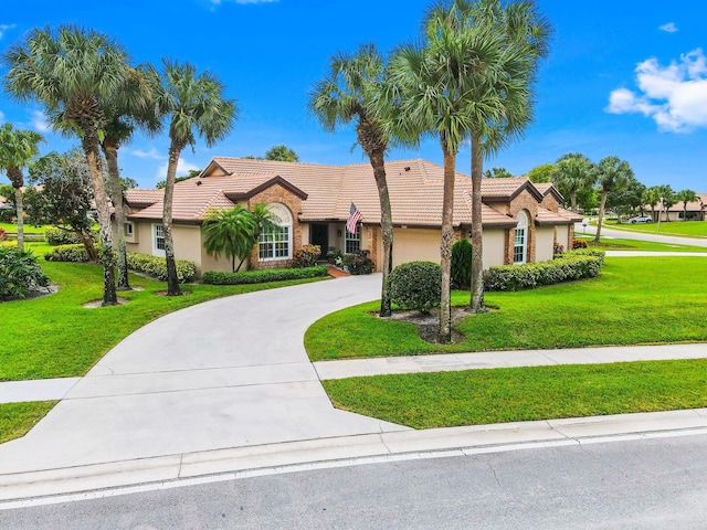 view of front of property featuring a garage and a front lawn