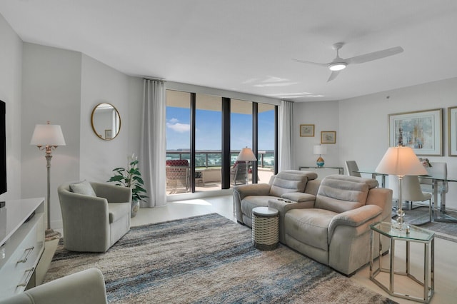 living room with ceiling fan and floor to ceiling windows