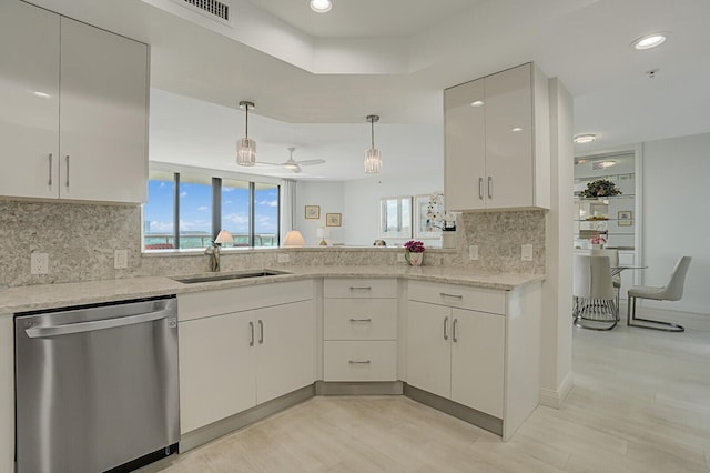 kitchen featuring decorative backsplash, ceiling fan, sink, dishwasher, and white cabinetry