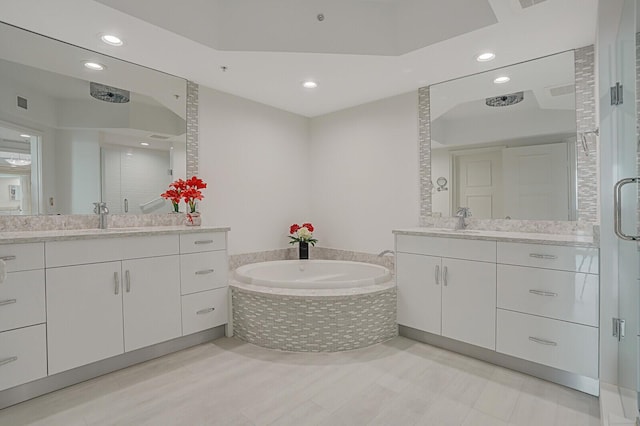 bathroom with vanity and independent shower and bath