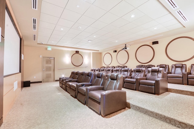 home theater room featuring a drop ceiling and light colored carpet