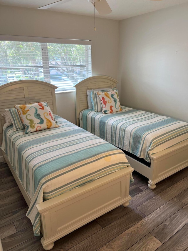 bedroom with dark hardwood / wood-style floors and ceiling fan