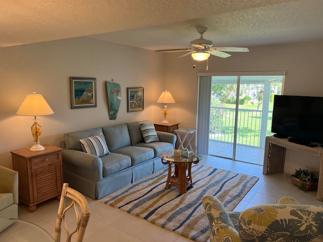 tiled living room with ceiling fan and a textured ceiling