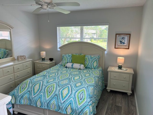 bedroom with ceiling fan and dark hardwood / wood-style flooring