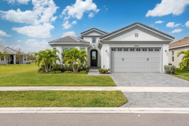 view of front of property with a front lawn and a garage