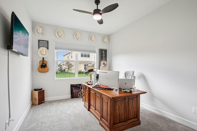 carpeted office space featuring ceiling fan