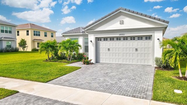 view of front of home with a front lawn and a garage