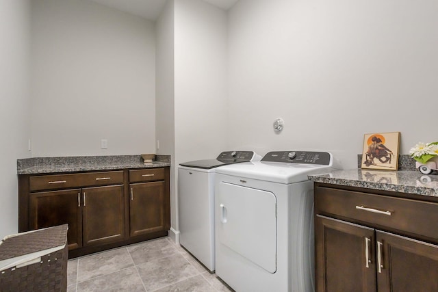 laundry room featuring cabinets and washing machine and clothes dryer