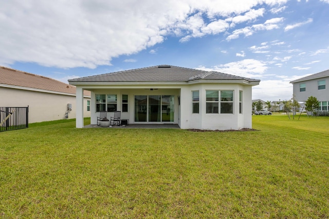 back of house featuring a patio area and a yard