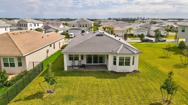 rear view of property with a lawn and a patio area