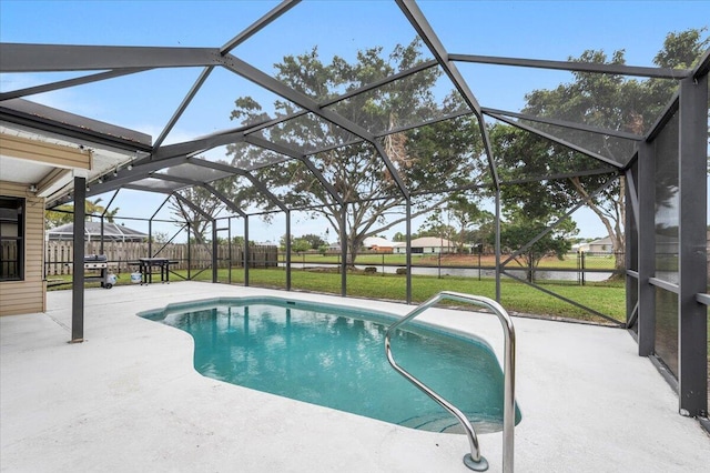 view of pool featuring a lawn, a lanai, and a patio