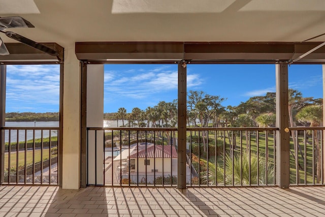 interior space with ceiling fan and a water view