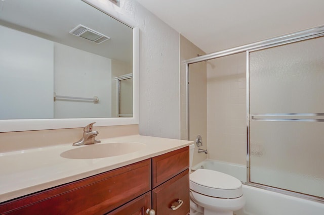 full bathroom with vanity, toilet, and shower / bath combination with glass door