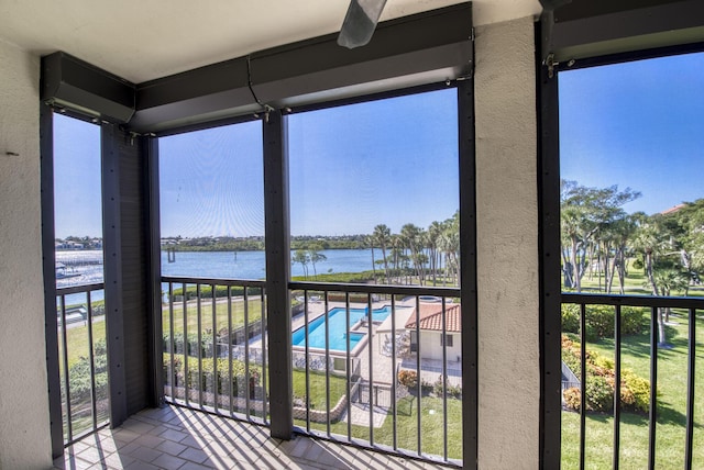 unfurnished sunroom featuring plenty of natural light and a water view