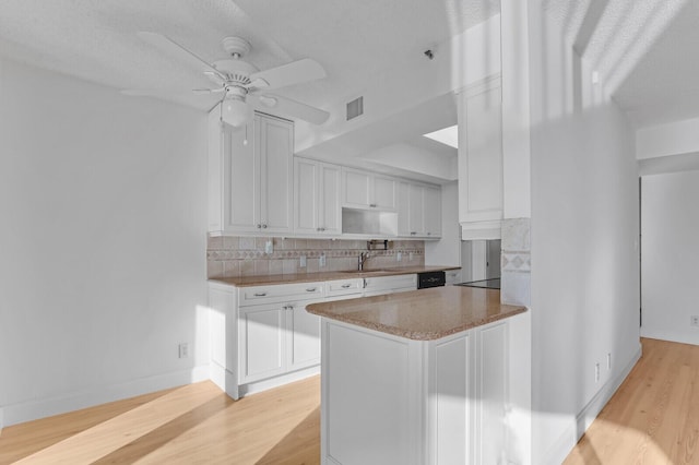 kitchen with tasteful backsplash, ceiling fan, sink, light hardwood / wood-style flooring, and white cabinets