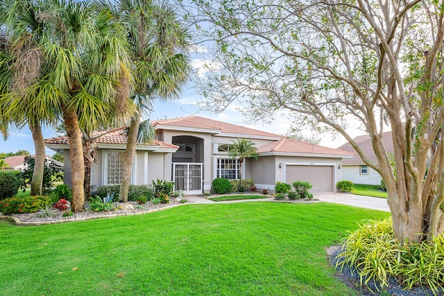 mediterranean / spanish house featuring a front lawn and a garage