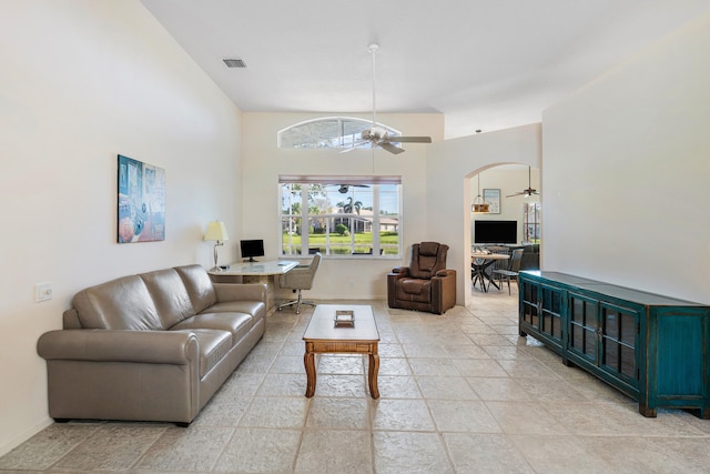 living room featuring high vaulted ceiling and ceiling fan