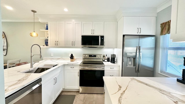 kitchen with white cabinets, pendant lighting, light stone counters, and appliances with stainless steel finishes