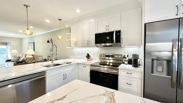 154 Lake Meryl Dr Unit 257, West Palm Beach, FL 33411 - kitchen featuring stainless steel appliances, white cabinetry, crown molding, hanging light fixtures, and light stone counters