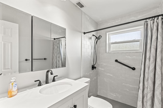 bathroom with curtained shower, vanity, and toilet