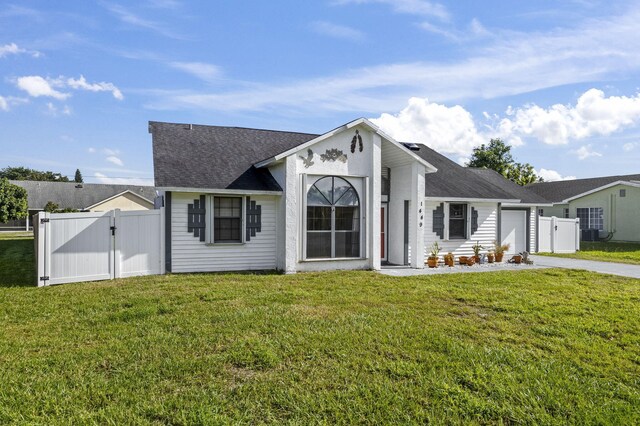 ranch-style home featuring a front yard