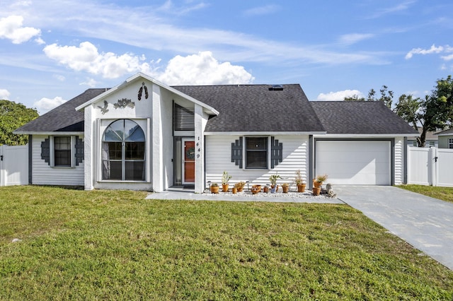 ranch-style house with a garage and a front lawn