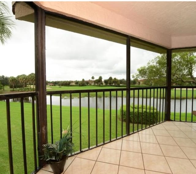 unfurnished sunroom with a water view