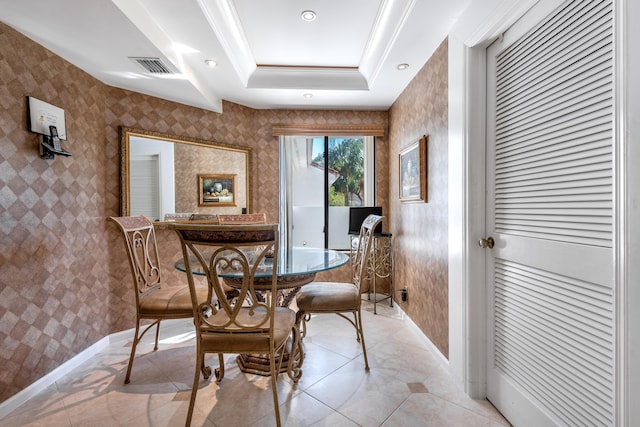 dining space featuring a tray ceiling, crown molding, and light tile patterned floors