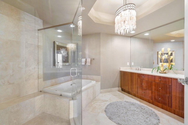 bathroom with vanity, shower with separate bathtub, and a notable chandelier