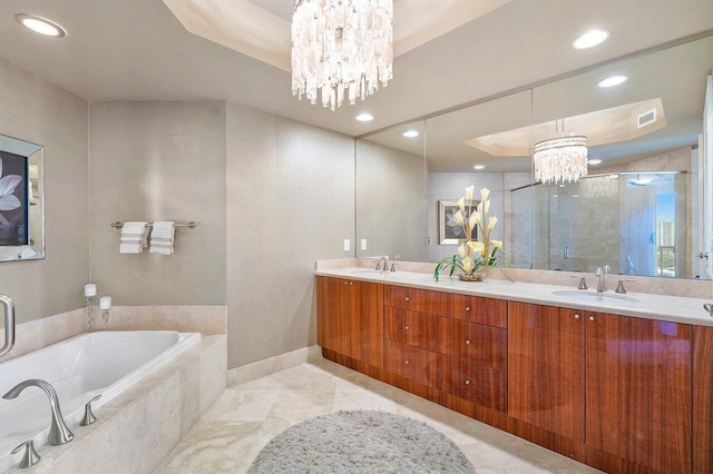 bathroom with vanity, shower with separate bathtub, and a chandelier