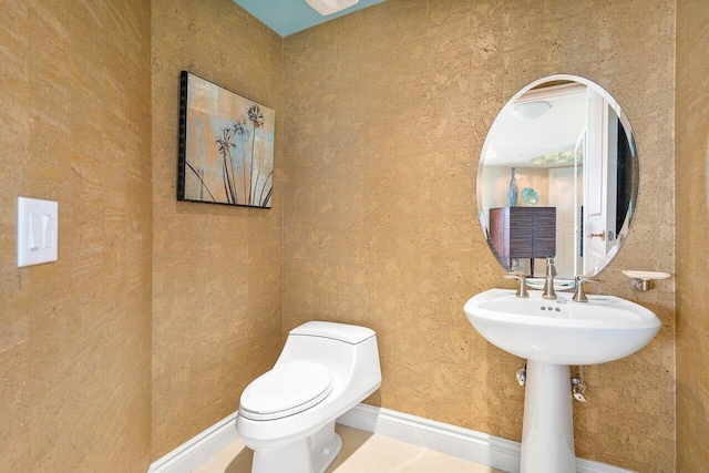 bathroom with tile patterned floors and toilet