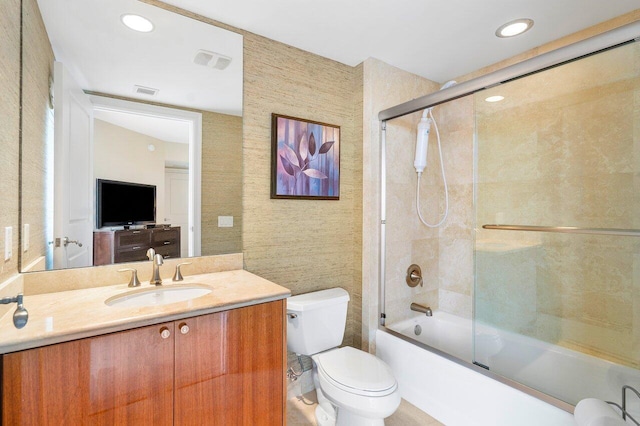 full bathroom featuring shower / bath combination with glass door, vanity, and toilet