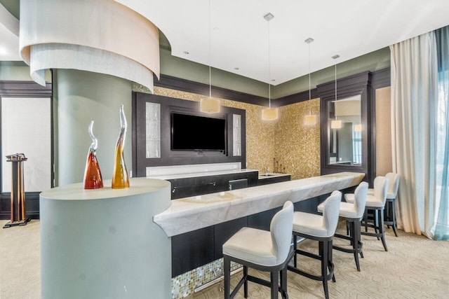 bar featuring light carpet and hanging light fixtures