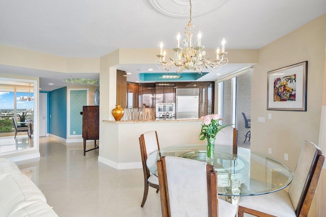 tiled dining area featuring a notable chandelier