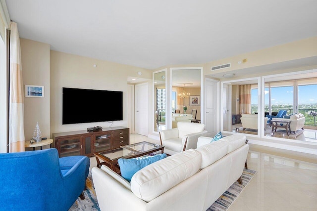 living room featuring light tile patterned floors and an inviting chandelier