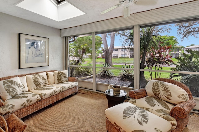 sunroom / solarium featuring ceiling fan and a skylight