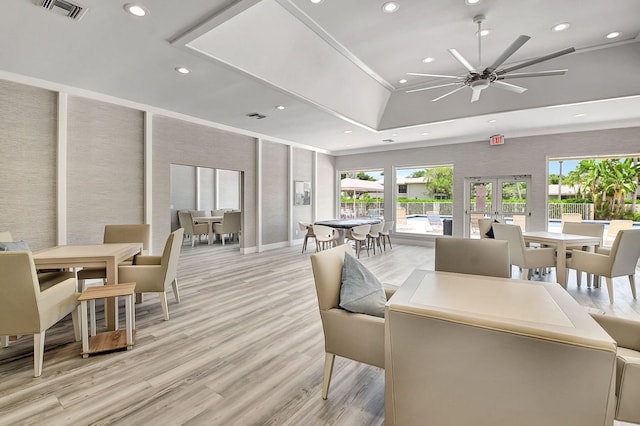 dining room featuring ceiling fan, light hardwood / wood-style flooring, and french doors