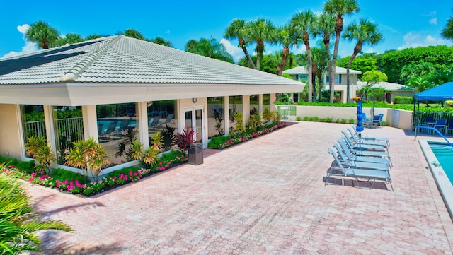 view of pool featuring a patio area and french doors