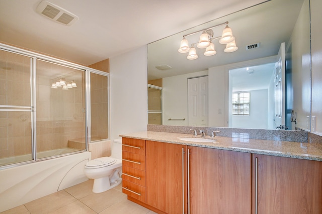 full bathroom featuring tile patterned floors, vanity, toilet, and enclosed tub / shower combo