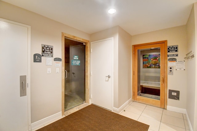 hallway featuring light tile patterned flooring